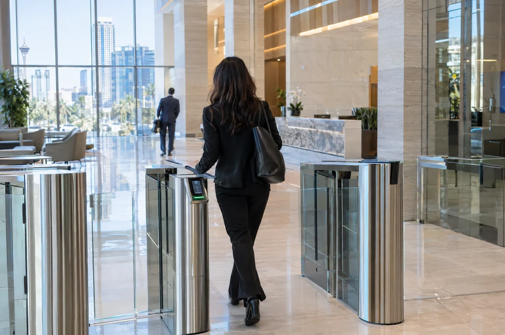 Woman using an entry gate in an office lobby, for Las Vegas access control Woman using an entry gate in an office lobby, for Las Vegas access control